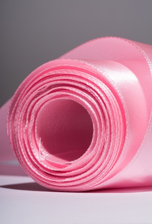 Hank silk pink ribbon, close-up, macro on a grey backgroundの写真素材