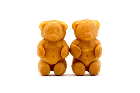 Sweets in the form of teddy bears with condensed milk isolated on a white background