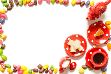 Coffee tea in red mug with candy and cake isolated on white background. Top view.の写真素材