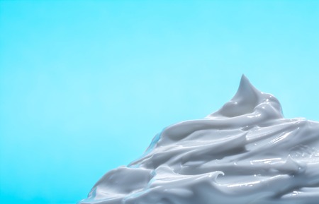 White cosmetic cream close-up macro texture on blue backgroundの写真素材