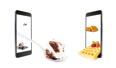 A conceptual creative 3D volumetric photo of a various sweets, cake on a spoon, toast with raspberries, outside the screen of a smartphone, isolated on a white background.の写真素材