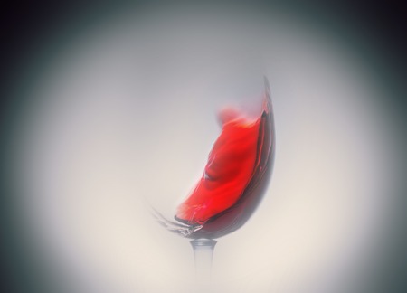 Red wine splash in the wineglass close-up macro texture background. Vintage old retro style view. Soft focus.の写真素材