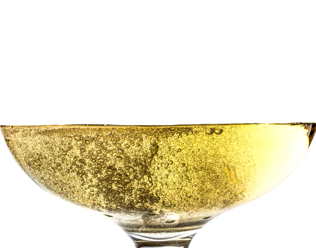 Splash white wine in glass with bubbles close-up macro texture isolated on top on white background. Wave of white wine with beautiful fizz.の写真素材