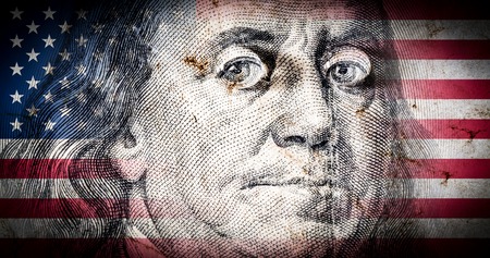 Flag of America with old grunge texture and portrait of Benjamin Franklin on one hundred dollars close upの写真素材