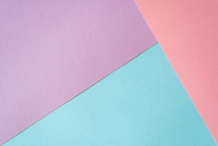 Multicolored paper background in soft blue, lilac and coral colors.