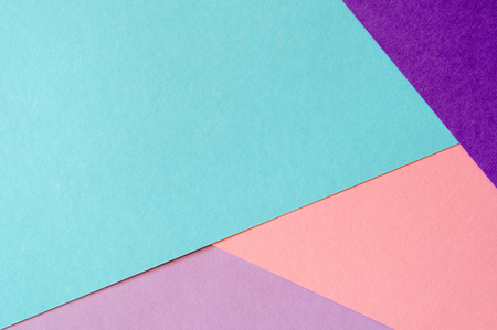 Multicolored paper background in soft blue, violet, lilac and coral colors.の写真素材