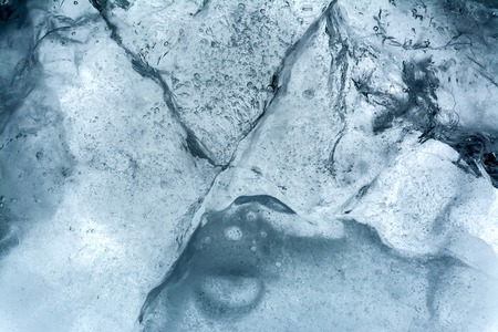 Ice texture background macro close up in sunlight. Beautiful abstract patterns of frozen water.