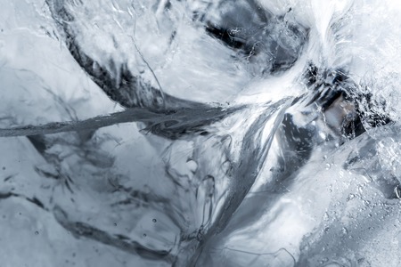 Ice texture background macro close up in sunlight. Beautiful abstract patterns of frozen water.