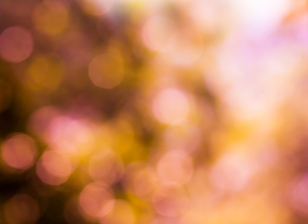 Summer abstract bokeh background in soft warm pastel orange and pink tones with sun rays. Beautiful...