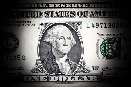 Close-up portrait of George Washington on a US 1 dollar banknote.