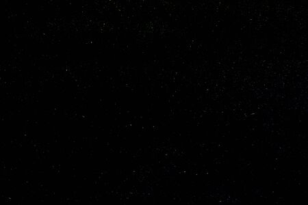 Background of the night clear sky with luminous multi-colored stars.の写真素材