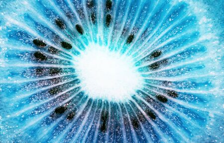 Creative macro photo of a close-up of a kiwi fruit core in a 2020 color trend in blue tones. Blue kiwi fruit. Creative ideaの写真素材