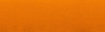 Good quality porous orange color cardboard paper texture close-up.の写真素材