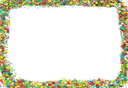 Bright isolated frame made of multi-colored sweet sprinkles of different shapes in the form of hearts, stars, moon, flowers, round balls and sticks.の写真素材