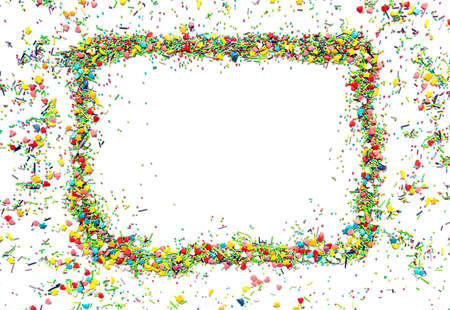 Bright isolated frame made of multi-colored sweet sprinkles of different shapes in the form of hearts, stars, moon, flowers, round balls and sticks.の写真素材