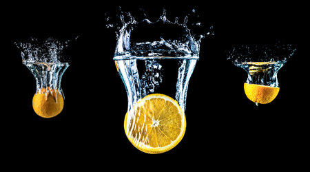 Composition of oranges falling into water close-up, macro, splash water, bubbles, isolated on a...