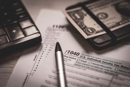 U.S. individual and corporation income tax return close-up next to a calculator, dollars, money, a...