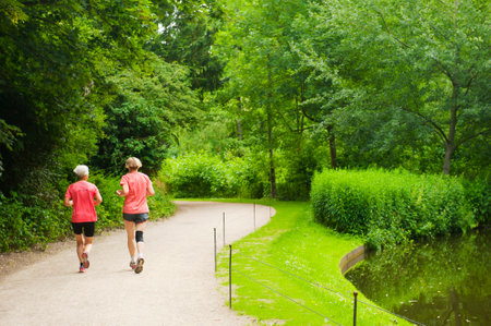 COPENHAGEN, DENMARK - JULY 3  Women running in the park Frederiksberg Have on July 3, 2014 in Copenhagen のeditorial素材
