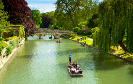 CAMBRIDGE, ENGLAND - MAY 28: Trinity College, University of Cambridge. Punting on the River Cam on...