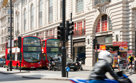 LONDON, ENGLAND - MAY 30: Double-deckers and motorcyclists near Piccadilly Circus on May 30, 2015 in Londonのeditorial素材