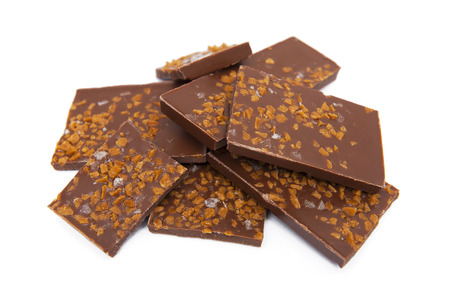 Chocolate with caramel and salt pieces isolated on white backgroundの写真素材