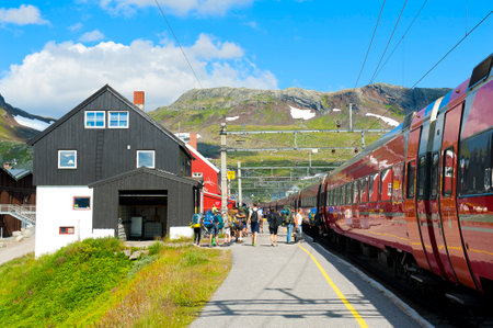 FINSE, NORWAY - JULY 28, 2019: Passengers getting on the train at the railway station in Finseのeditorial素材