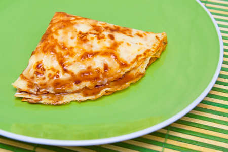 Close up of pancake on green plateの写真素材