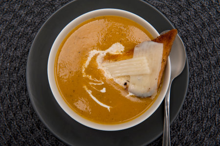 Top view of onion soup with cream and toast with goat milk cheese isolated on white backgroundの写真素材