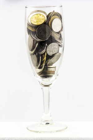 coins in a wine glassの写真素材
