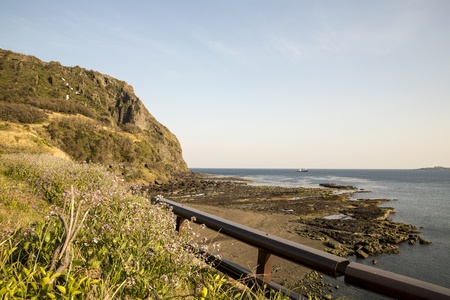 Mountian and sea with clear blue sky background at Jeju Island, South Koreaの写真素材