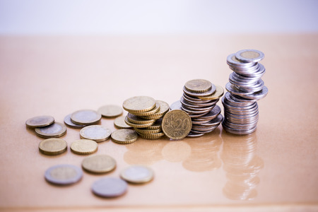 Mortgage loan and real estate tax macro financial Concept, Scandinavian house model and pile of...