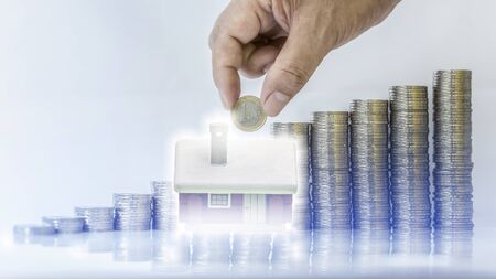Double exposure image of money stacking as big growth of profit or successful of house construction...