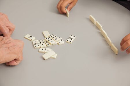 Grandfather and grandson playing game Dominoes.の写真素材