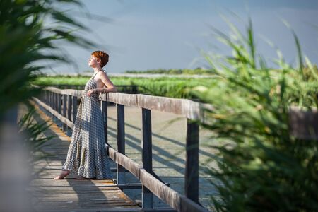 WELL-BEING, WOMAN ACCOUDED ON A GATEWAYの写真素材