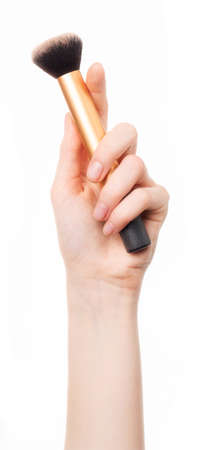 A woman's hand holding a makeup brush.の写真素材