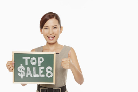Businesswoman holding up a Top Sales" sign"の写真素材