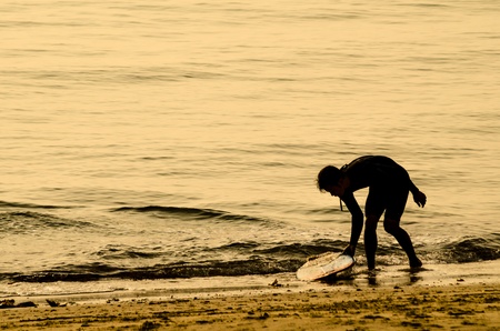 The sea of evening glow, and a young man s surfer の写真素材