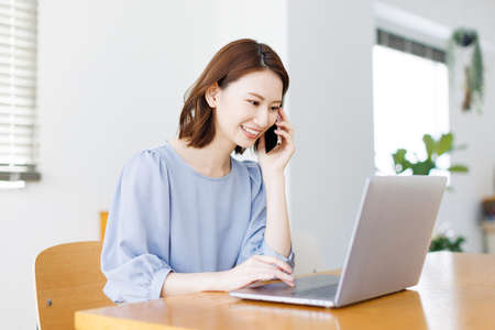 Young Asian woman having a phone callの写真素材