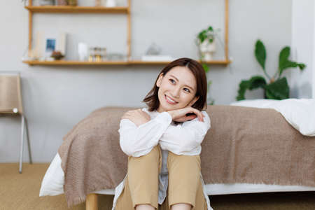 Young Asian woman relaxing at homeの写真素材
