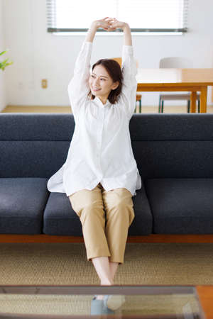 Young Asian woman stretching her armsの写真素材
