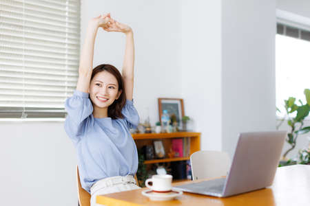Young Asian woman stretching her armsの写真素材