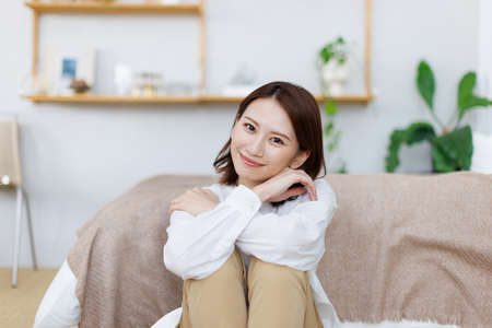 Young Asian woman relaxing at homeの写真素材