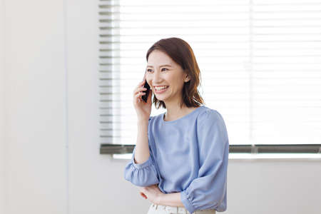 Young Asian woman having a phone callの写真素材