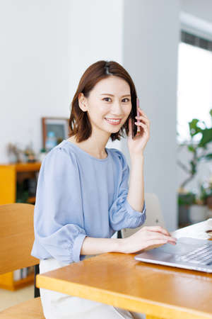 Young Asian woman having a phone callの写真素材