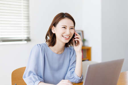 Young Asian woman having a phone callの写真素材
