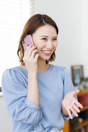 Young Asian woman having a phone callの写真素材