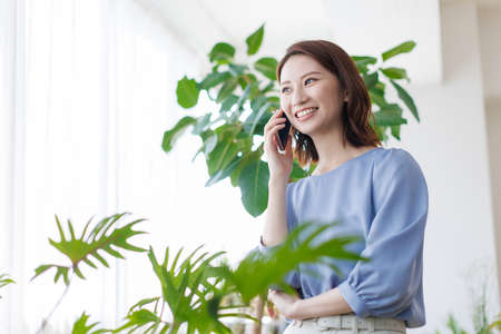 Young Asian woman having a phone callの写真素材
