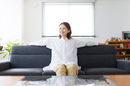 Young Asian woman relaxing at homeの写真素材