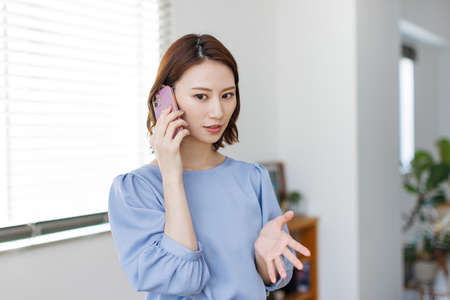 Young Asian woman having a phone callの写真素材