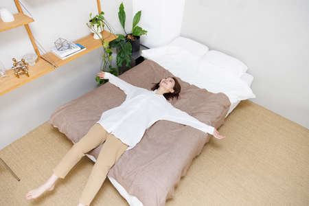 Young Asian woman relaxing at homeの写真素材